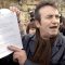 Gerry Conlon showing the letter of apology he received from Tony Blair to media outside the House of Commons in 2005